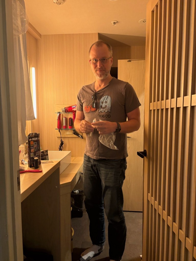 A man in a small hotel room